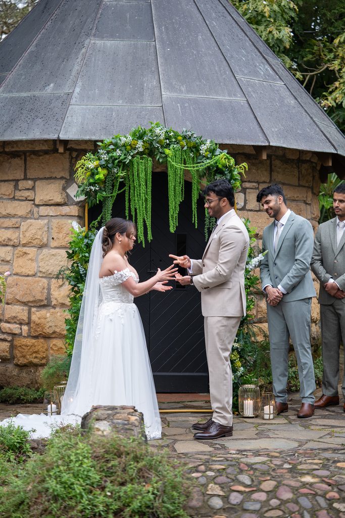 Bride and Groom playing rock, paper, scissor to decide who says their vows first